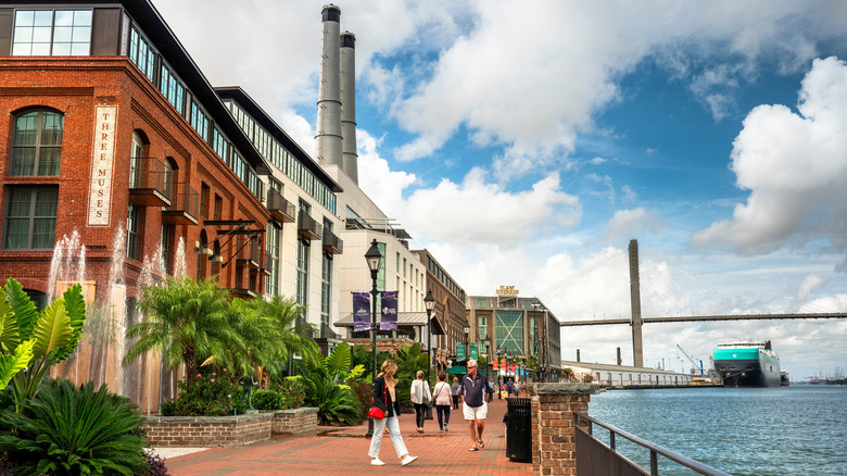 What should you do along the Savannah riverfront and downtown districts?