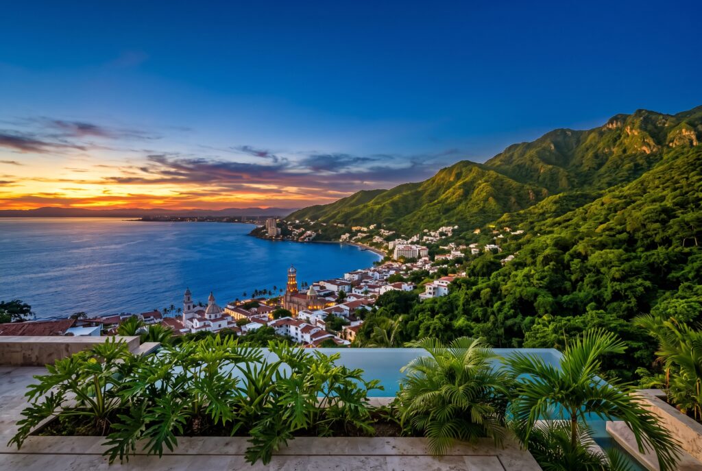 Panoramic sunset view of the blue ocean and green Sierra Madre mountains, showcasing the top things to do in Puerto Vallarta.