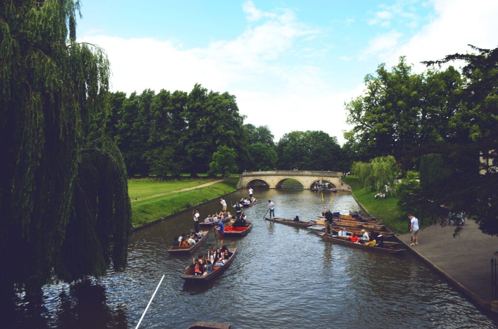 Visitors enjoying traditional punting on the River Cam during popular london day trips.