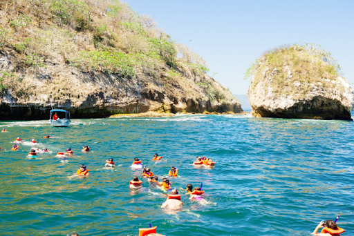 Snorkeling around the rock formations at Los Arcos Marine Park, one of the top-rated Puerto Vallarta tourist activities.